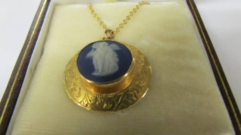 A 9ct gold pendant set Wedgwood plaque on gilded chain, (brooch attachment has been removed). - Image 3 of 3