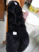A Saks Fifth Avenue real fox fur scarf in black, with original tags.