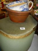 A green wicker laundry bin and a china pot.