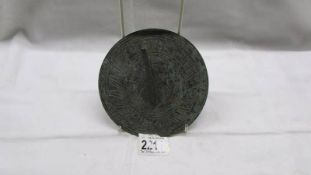 A 19th century bronze sundial. Diameter 14.5cm.