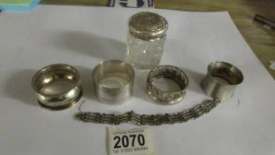 Four silver napkin rings, a silver lidded pot and a silver bracelet, 88 grams of silver in total.