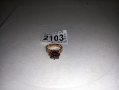 A 9ct gold garnet cluster ring, size N half, 3.6 grams.
