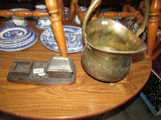 A small brass coal scuttle and an oriental cast metal smokers desk stand.