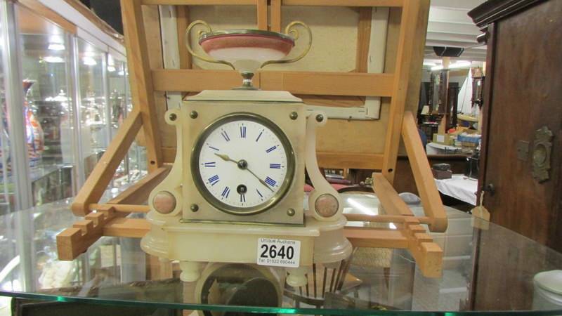 A small marble mantel clock. In working order.