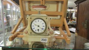 A small marble mantel clock. In working order.