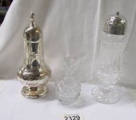 A silver plate sugar sifter, a glass sugar sifter and a glass scent bottle.