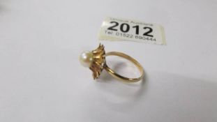 A yellow metal ring set pearl (tests as 9ct gold), size R. 3.5 grams.