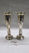 A pair of decorative silver spill vases, 15cm. (one has repair on base).