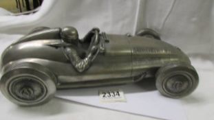 A heavy metal model of a Mercedes racing car.