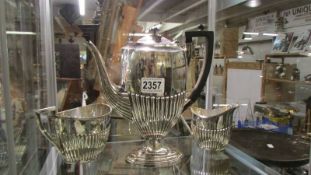 A three piece silver plate coffee set.