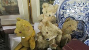 Four vintage teddy bears.