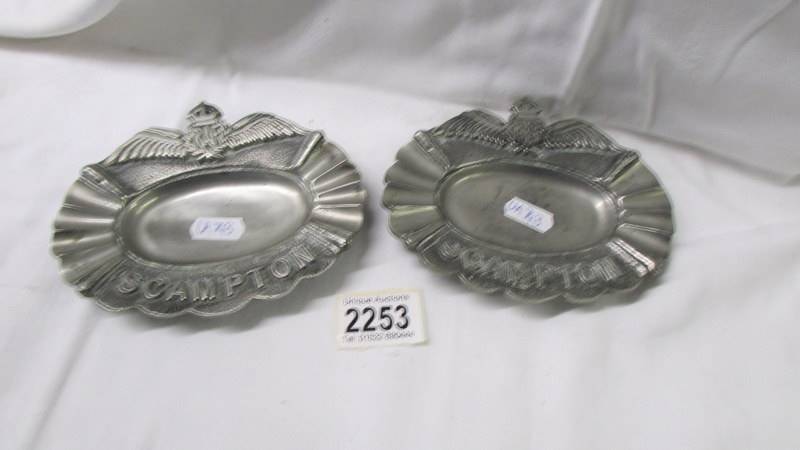 A pair of cast "R.A.F Scampton" ash trays.