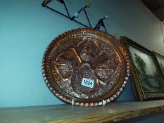 An ornate hammered copper tray diameter 29.5cm