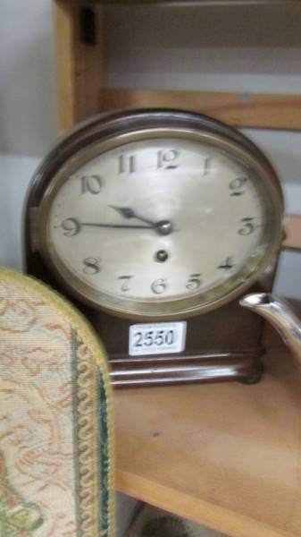 A mantel clock with silvered dial in working order.