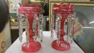 A pair of cranberry glass lustres (one a/f chip to rim) COLLECT ONLY.