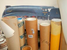 A quantity of train posters in tubes.