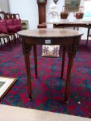 A circular table with carved floral edges and pad feet. (66cm diameter) COLLECT ONLY