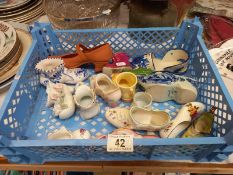 A collection of porcelain (plus 1 clay) shoes and boots
