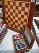 An inlaid chess board and a box containing playing cards etc.,