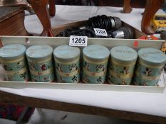 A retro tin spice tins in shelf bracket