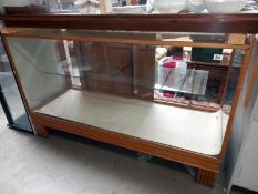 A glass display chest, wood frame and base (52cm x 59cm x 92cm height)
