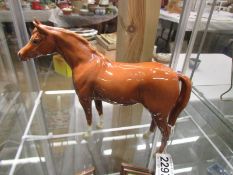 A Beswick horse. A/F Left, rear, leg has been glued back on.