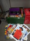 A box of knitting patterns and knitting needles