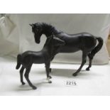 A Beswick black horse with foal, in good condition.