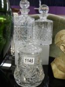 A quantity of cut glass including 2 decanters & biscuit jar. Collect Only.