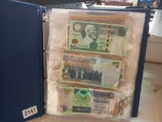 An album of approximately 86 world bank notes.