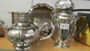 A silver plate tray, teapot, coffee pot and two wine bottle stands.