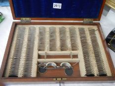 A vintage wooden opticians case with contents. COLLECT ONLY.