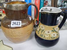 A Doulton stoneware jug with silver rim and one other jug.