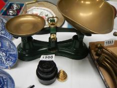 A set of kitchen scales with brass and metal weights.