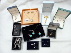 A quantity of ornate boxed earring and necklace sets