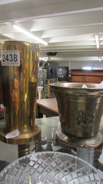 An early heavy brass vase and an old mortar.
