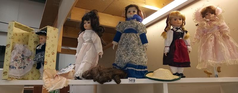 A shelf of collectors dolls