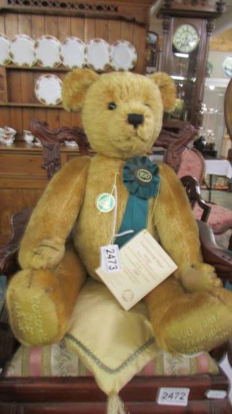 A limited edition Hermann centenial bear with cushion.