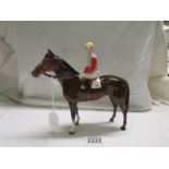 A Beswick horse with jockey, 1963-1984. In good condition.