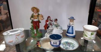 A shelf of decorative porcelain figurines etc.