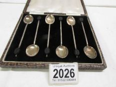 A cased set of six silver coffee spoons.