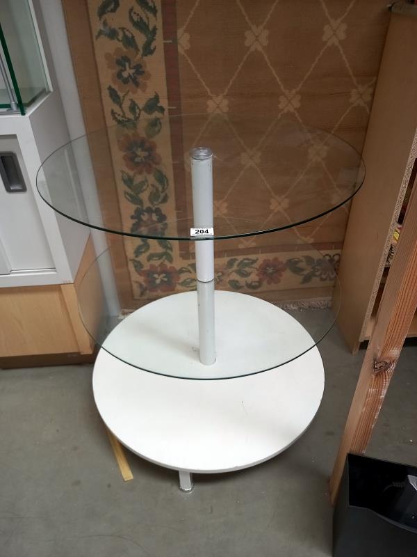 A circular display table, 2 glass shelves and wood base shelf ( 73cm diameter x 82cm tall)