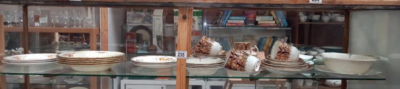 A shelf of various porcelain dinner & tea ware