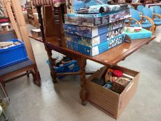 A 1930's oak drop leaf table with barley twist cross stretcher base. 92cm x 92cm x 76cm. Collect