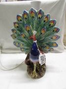 A peacock table lamp. Collect Only.