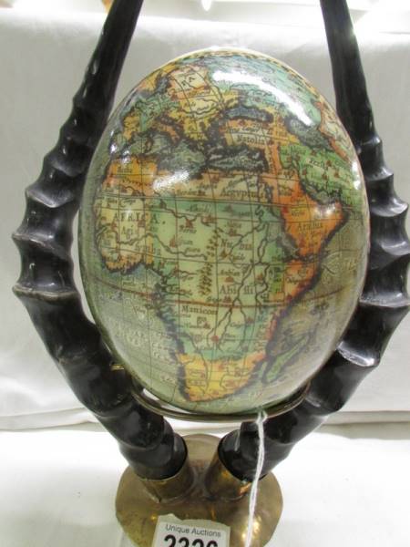 A decorated ostrich egg depicting elephants and other wild animals. - Image 4 of 5