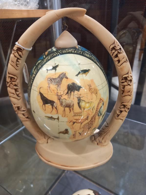 A decorated ostrich egg depicting elephants and other wild animals. - Image 4 of 6