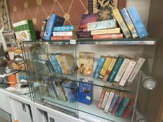 A mixed selection of romantic novels by Barbara Erskine, Susan Sallis and Josephine Cox. 3 shelves