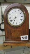 A mahogany inlaid mantel clock.