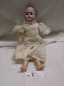 A Victorian porcelain doll marked PR, SFBJ, 60 Paris, missing wig & hairline crack to back of head.